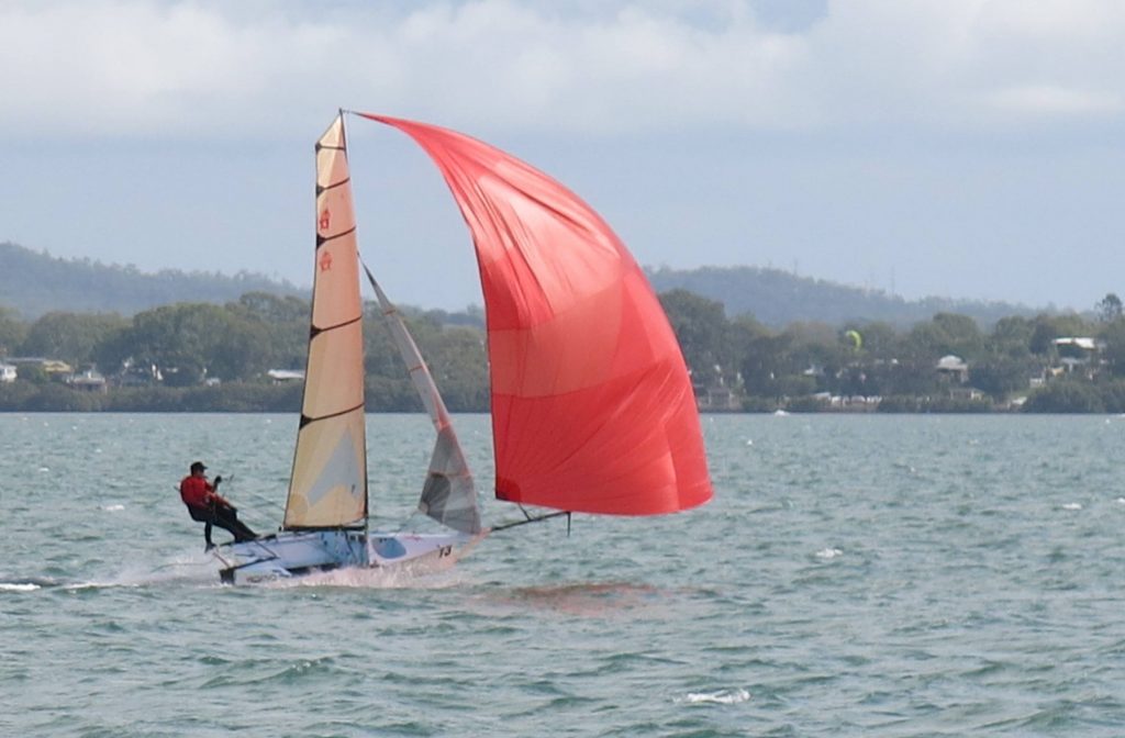 12ft skiff with red spinnaker