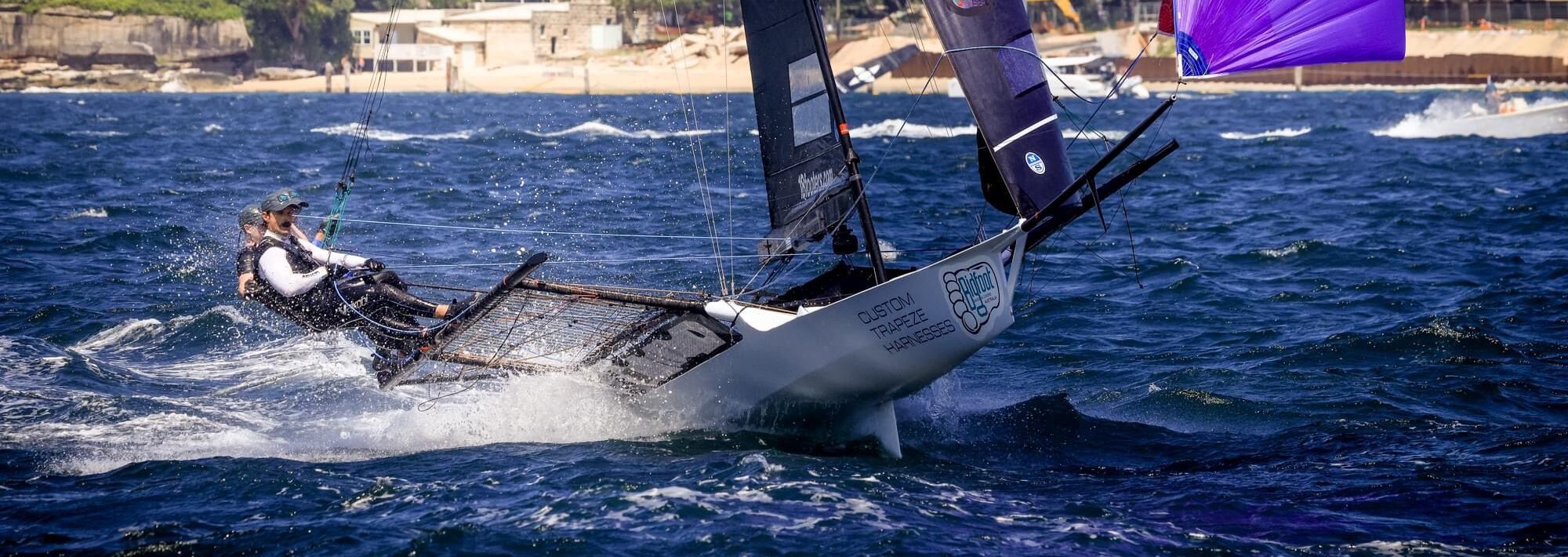 18 foot skiff with spinnaker jumping through waves